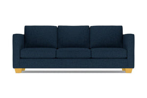 The Catalina Sofa is a dark blue three-seater featuring square cushions and light wooden legs, set against a white background.