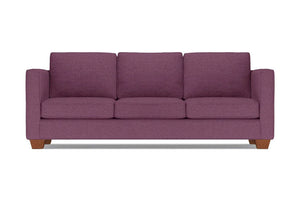 The Catalina Sofa, a plum-colored three-seater with wide armrests and wooden legs, is set against a plain white background. It features three plush seat and back cushions.
