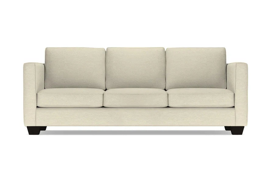 Introducing the Catalina Sofa: a three-seater in beige with square cushions and armrests, featuring black wooden legs, elegantly showcased against a white background.