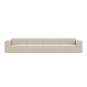 The Four-Seater Form Sectional is a long, beige modular sofa featuring four sections and square armrests. Set against a plain white background, it highlights its minimalist and contemporary design.