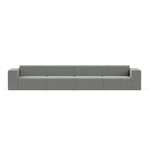 A large, modern Four-Seater Form Sectional in gray is showcased against a plain backdrop. Its minimalist design includes four wide seats and square armrests, offering a sleek and contemporary appearance.