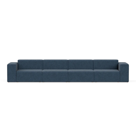 A sleek, contemporary blue Four-Seater Form Sectional featuring flat cushions and simple, straight armrests. It stands on square metal legs and is displayed against a plain white backdrop.