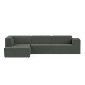 The Four-Seater Form Sectional is a dark green modular sofa with a modern design, featuring three main seating sections and a left chaise lounge. Set against a plain black background, the sofa boasts clean lines and a minimalist aesthetic.