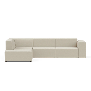 The Four-Seater Form Sectional is a modern, beige sofa featuring clean lines and a minimalist design. It includes a chaise lounge section on the left, all set against a plain, black background.