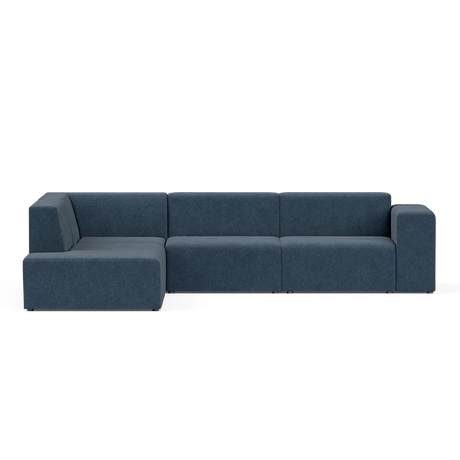 A contemporary sectional sofa called the Four-Seater Form Sectional, featuring a sleek design in navy blue with three interconnected seats and a left-side chaise lounge, set against a plain white background. The design boasts clean lines and minimalist aesthetics.