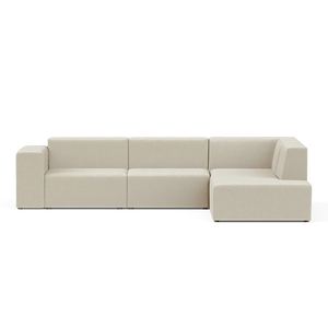 The Four-Seater Form Sectional is a spacious, contemporary beige sofa with a sleek, minimalist design. It boasts clean lines and an inviting appearance with a right-facing chaise lounge, set against a simple black backdrop.