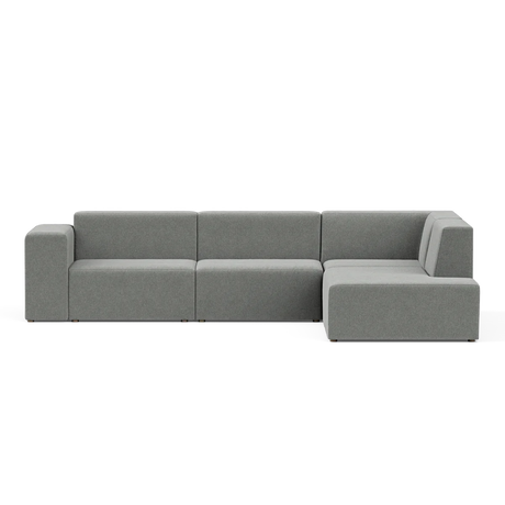 The Four-Seater Form Sectional is a contemporary gray sofa with a minimalist design, characterized by clean lines and square cushions. It includes a right-side chaise, offering plenty of seating space.