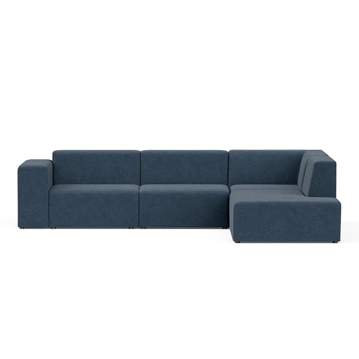 The Four-Seater Form Sectional is an L-shaped sofa in navy blue, featuring a minimalist design with flat backrests and armrests. Its spacious seating sits elegantly against a neutral background, making it perfect for modern living rooms.