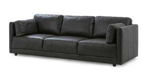 The Domus 93" Leather Sofa, Chestnut is a sophisticated piece featuring three seat cushions with matching back cushions. Its modern design includes square armrests and it comes with two decorative pillows on each end for added style.