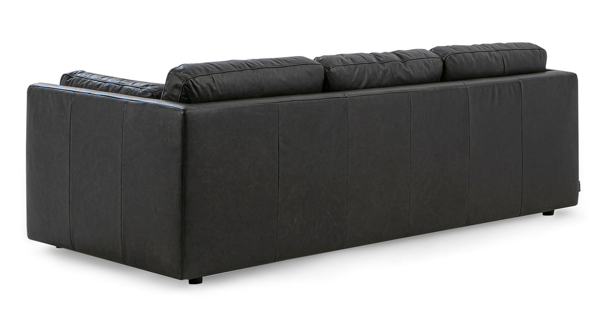 A back view of the Domus 93" Leather Sofa in chestnut leather, featuring four plush cushions and a boxy design, set against a white background.