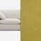 A cream-colored sofa with plush cushions is partially visible on the left side. The right side of the image shows a solid mustard yellow background.