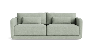 Introducing the Eva 85" Sofa, a modern piece in a light gray hue featuring two spacious seat cushions and two large back cushions. It comes with two smaller matching pillows, showcasing clean lines and a minimalist design against a plain black background.