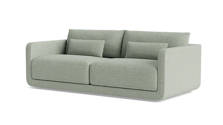 The Eva 85" Sofa is a modern piece in light green featuring two large seat cushions, two back cushions, and two smaller rectangular pillows. Its sleek and contemporary design includes straight armrests and exudes a minimalist style.