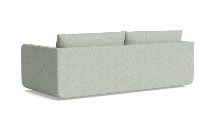 The Eva 85" Sofa is a minimalist piece with a boxy design in light gray, featuring two back cushions. Against a black background, its clean lines and modern aesthetic are perfectly highlighted.