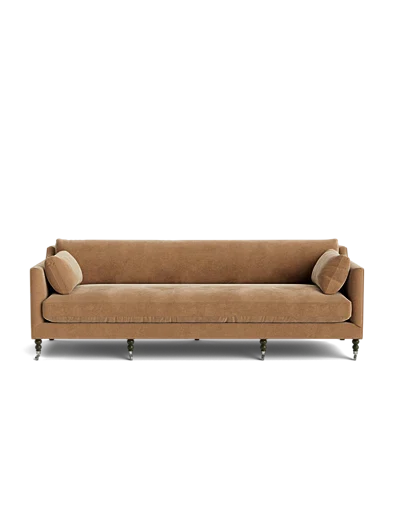 The Fabienne Sofa, featuring a brown upholstered design with wooden legs and two matching cylindrical pillows on either side, is set against a plain white background.