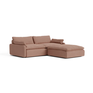 The Sink Down Sectional, a brown sectional sofa with a chaise lounge on the right, features thick cushions and armrests, set against a plain white background.