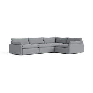 The Sink Down Sectional is a large, gray, L-shaped sofa with thick cushions and a modern design, placed against a plain background.