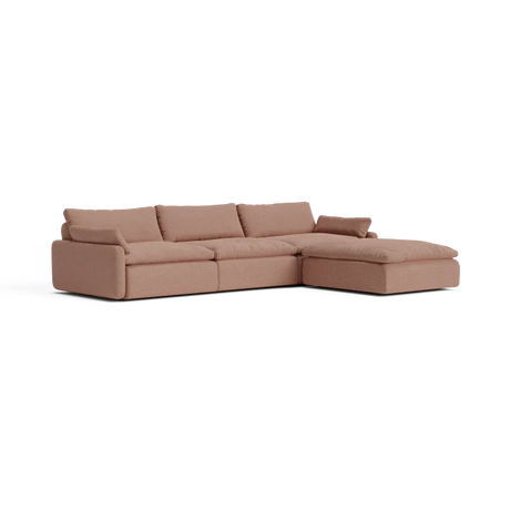 Introducing The Sink Down Sectional: a contemporary L-shaped sofa in a cozy warm brown tone. This sectional boasts a smooth texture, complete with three main seat cushions and an attached chaise on the right side. The plush back cushions provide exceptional comfort for a relaxing seating experience.