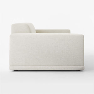 Side view of the Faible 100" White Performance Fabric Sofa against a white background, featuring a modern and minimalist design. This sofa showcases a boxy structure with plush cushioning, broad armrests, and a low backrest, accentuating its simple yet elegant style.