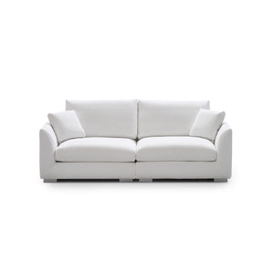 Introducing the Feathers 3-Seater Sofa, a sleek and modern white sofa accompanied by two matching cushions. Set on a plain white background, this sofa features a minimalist design with smooth, rounded armrests and plush seating, epitomizing clean elegance.