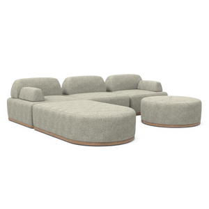 The Magna Preconfigured Sectional is a beige modular sofa with rounded sections and a matching round ottoman, featuring wooden bases. Its design is contemporary and minimalist, set against a white background.