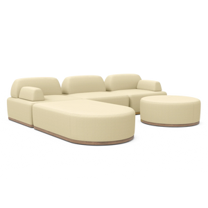 A contemporary cream Magna Preconfigured Sectional with modular curved edges and a coordinating round ottoman, all set against a white backdrop. It showcases cushioned backrests and smooth finishes, with a wooden base subtly exposed beneath.
