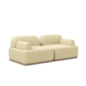 Magna Preconfigured Sectional in a modern beige hue, featuring clean lines and cushioned backrests set on a dark base, showcased against a plain white background.