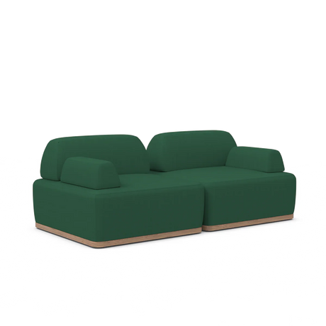 Introducing the Magna Preconfigured Sectional: a contemporary green sofa featuring two spacious sections with sleek, rounded edges on a light wooden base, perfectly highlighted against a plain white backdrop.