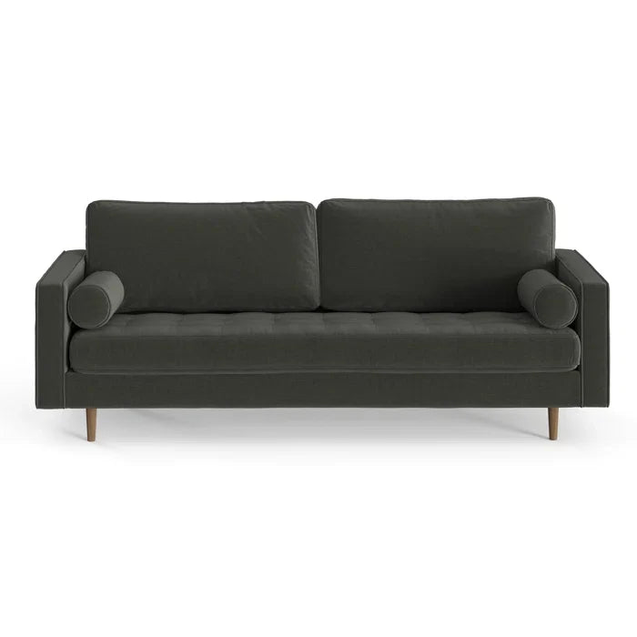Introducing the Geo 84'' Upholstered Sofa, a contemporary piece in dark green with wooden legs. It boasts a sleek, minimalist design featuring two square back cushions and complemented by cylindrical bolster pillows on each side.