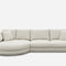 A modern, light gray sectional sofa with three cushions and two pillows on the right side. The left side features a rounded chaise lounge, creating a smooth, curved seat. The background is plain white.