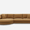A large, modern sectional sofa in a light brown color. The left side features a rounded chaise, and it includes plush cushions. The sofa has a minimalist design and rests on a slim, metal base against a white background.