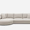 A modern beige sectional sofa with a round chaise on the left and three rectangular seat cushions. It has a clean, minimalist design and includes several matching throw pillows. The sofa is set against a plain white background.