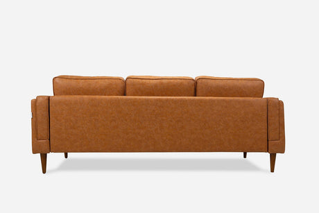 Back view of the Albany Sofa in camel brown vegan leather, featuring three seat cushions and four tapered wooden legs, set against a plain white background.