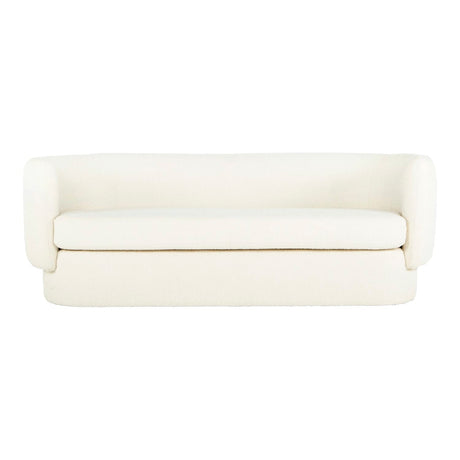 Introducing the Koba Sofa: A simple white sofa boasting curved armrests and a sleek, minimalistic design. This piece offers a smooth, cushioned surface and is placed against a plain white background.