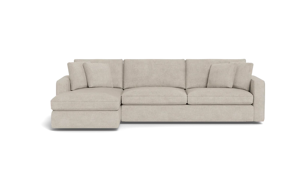 The James 3 Seat Left Chaise 92" Sectional boasts a modern, light beige color and an L-shaped design against a black background. It includes three seat cushions, back cushions, and two square throw pillows for a sleek and comfortable seating arrangement.