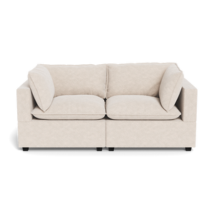 The Kova Pillow Cushion Sofa 86" is a beige two-seater with square cushions and armrests on both sides, shown against a white background.