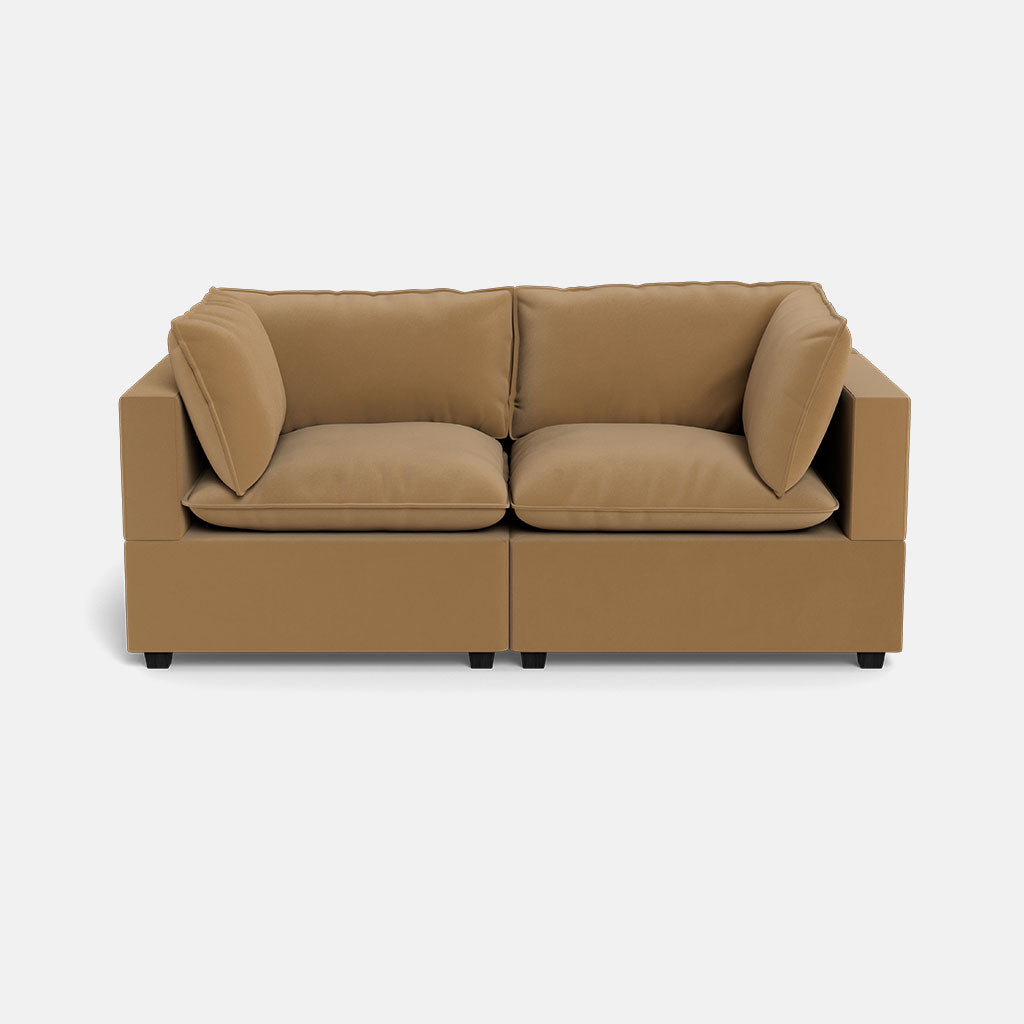 The Kova Pillow Cushion Sofa 86" is a modern, tan two-seater with plush cushions and square arms, shown against a plain white background.