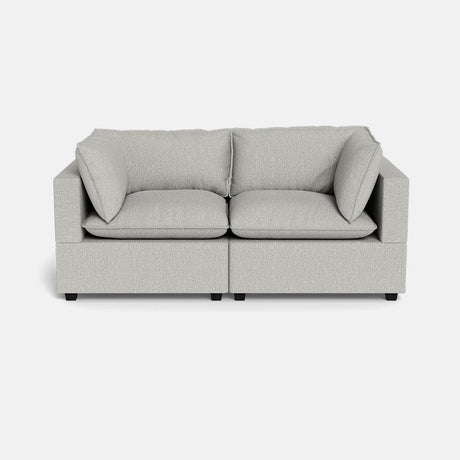 The Kova Pillow Cushion Sofa 86" is a modern, light grey two-seater with square arms and plush cushions, displayed against a plain white background.