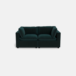 The Kova Pillow Cushion Sofa 86" is a modern dark green velvet sofa with two seat cushions and four back cushions, displayed against a plain light gray background.