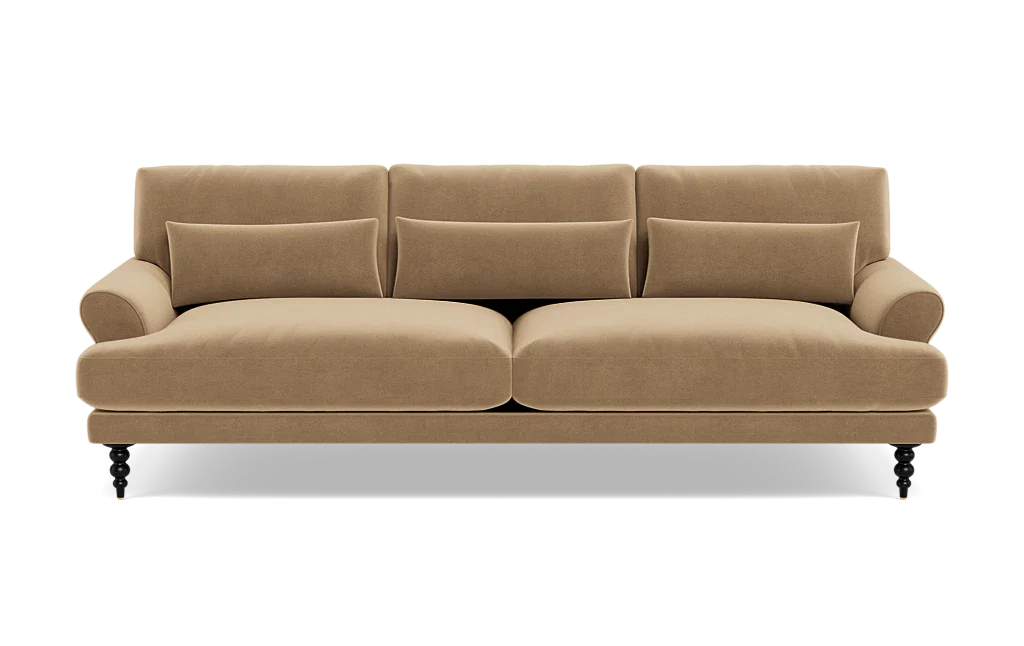 The Maxwell Custom Sofa is a tan, three-seater with plush cushions and rounded armrests, set on dark carved legs, shown from the front against a white background.