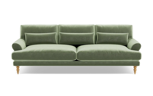 The Maxwell Custom Sofa is a chic piece, upholstered in luxurious green velvet, with three back cushions and two seat cushions. It is designed with rounded armrests and wooden legs, offering a modern and elegant appearance.