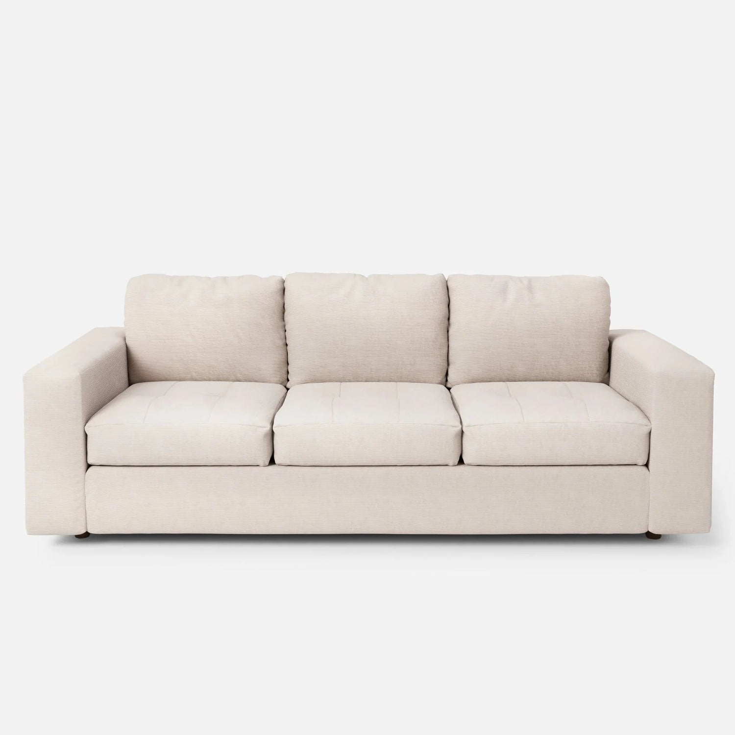 The Marc Tufted Sofa, a beige three-seater with plush cushions and a minimalist design, is set against a plain white background.