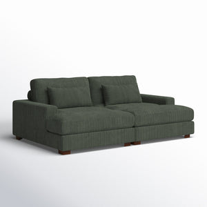 An Etta Avenue Mordecai 90'' Square Arm Sofa upholstered in dark green corduroy, featuring two spacious seat cushions, two back cushions, and two decorative pillows. The sofa showcases a modern design with wooden legs and is displayed against a plain white background.
