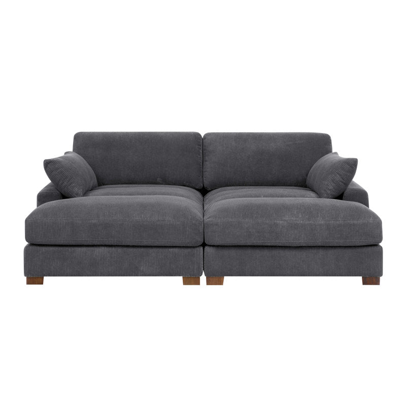 The Etta Avenue Mordecai 90'' Square Arm Sofa is a modern gray corduroy sectional with two seat cushions, two back cushions, and two side pillows. It features short wooden legs and offers a cozy, minimalist design ideal for contemporary living spaces.