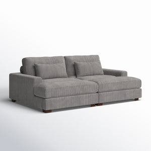 The Etta Avenue Mordecai 90'' Square Arm Sofa is a modern piece with a gray ribbed fabric texture, featuring two large seat cushions, two backrest cushions, and two smaller rectangular pillows. It has low arms and wooden legs, all set against a white background.