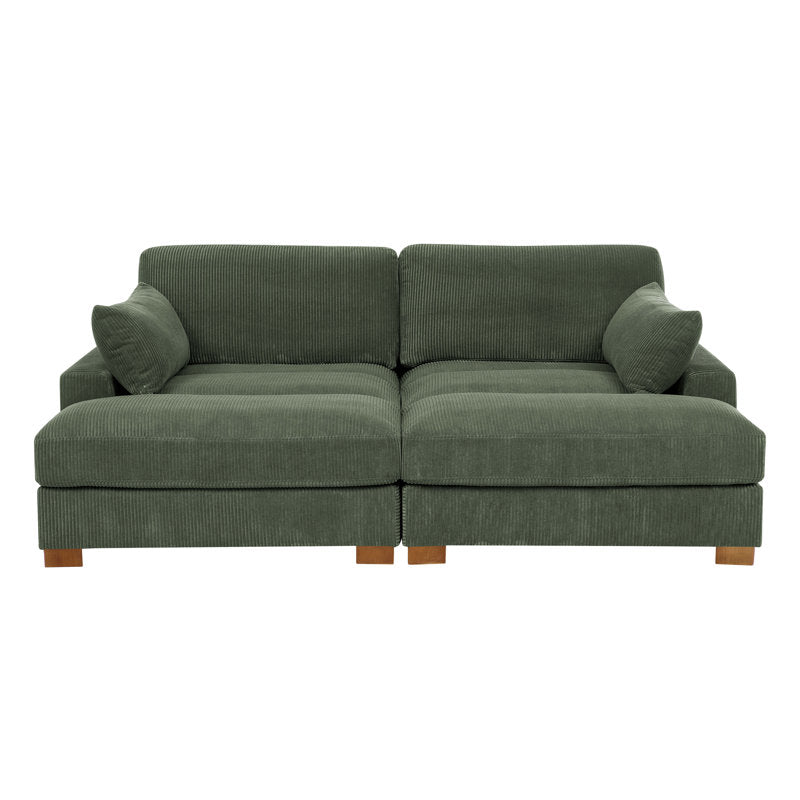 Introducing the Etta Avenue Mordecai 90'' Square Arm Sofa: a green upholstered sectional with stylish wooden legs. This sofa includes two large seats and comes with two matching green pillows on each side, all adorned in a textured, ribbed fabric design.