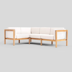 The Haven Sectional is a cream-colored L-shaped sofa with a wooden frame set against a plain gray background. It features cushions for both seating and back support, designed in a minimalist style.