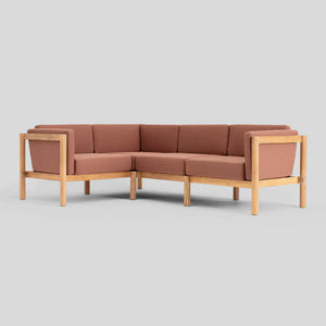 Introducing the Haven Sectional: a contemporary L-shaped brown sofa featuring a wooden frame and legs on a light gray backdrop. This piece combines modern style with natural elements, showcasing straight lines and firm cushions for a sleek look.