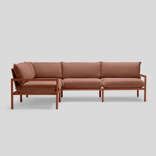 The Terra Sectional is a brown L-shaped sofa with a minimalistic design, featuring metal legs and cushioned seats and backs, set against a plain gray background.