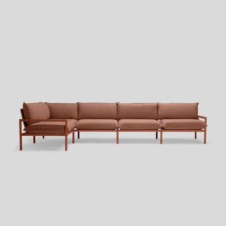 The Terra Sectional is a minimalist brown L-shaped sofa with a wooden frame, featuring cushioned seats and backrests, set against a light gray background.